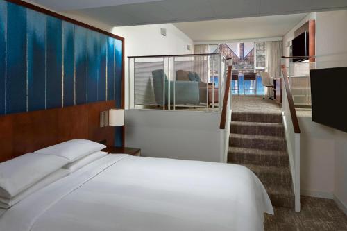 a hotel room with a bed and a staircase at Toronto Marriott City Centre Hotel in Toronto