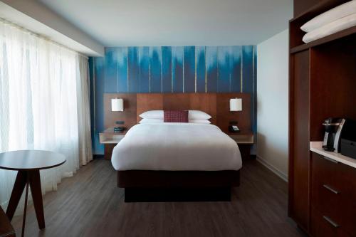 a hotel room with a bed and a table at Toronto Marriott City Centre Hotel in Toronto