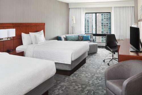 um quarto de hotel com duas camas e uma secretária em Courtyard By Marriott Jersey City Newport em Jersey City