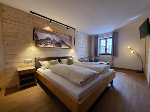 a bedroom with a large bed in a room at Landgasthof Wangerstuben in Oberostendorf