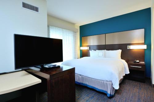 ein Hotelzimmer mit einem Bett und einem Flachbild-TV in der Unterkunft Residence Inn by Marriott Houston Northwest/Cypress in Cypress