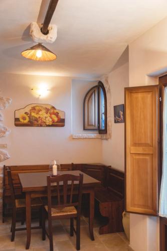 a dining room with a table and chairs and a light at Masseria Montanaro in Cisternino