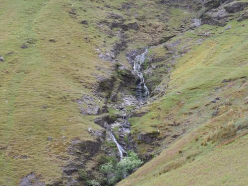 a waterfall on the side of a mountain at 3 Cambridge Villas in Ambleside