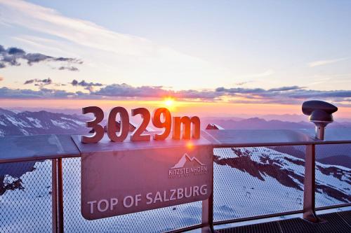 a view of the top of a mountain with the sun setting at Pension Monika, Cozy B&B, newly renovated rooms in Kaprun in Kaprun