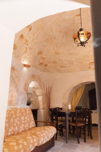 a living room with a table and a couch at Masseria Montanaro in Cisternino