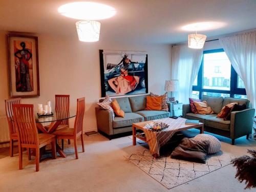 a living room with a couch and a table at Central spacious and secure with a double bed in Colindale