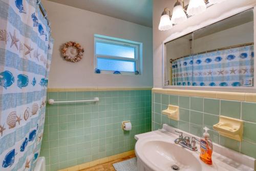 a bathroom with a sink and a mirror at Home Away from Home Daytona 3 Bedroom in South Daytona