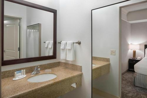 a bathroom with a sink and a mirror at SpringHill Suites Napa Valley in Napa