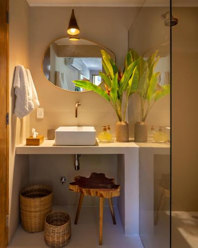 a bathroom with a sink and a mirror at Alma Ninho Trancoso in Trancoso