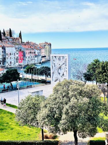 a view of a city and the ocean with trees at Loreto LYA SEA VIEW APARTMENTS in Rovinj