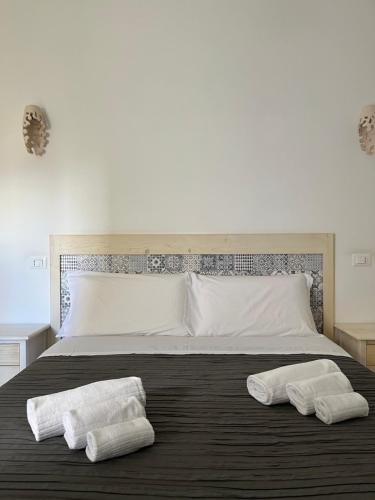 a bedroom with a bed with two towels on it at Donna Nina in Monopoli
