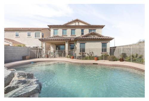 a large swimming pool in front of a house at Olivia Jones Residence I in San Tan Valley