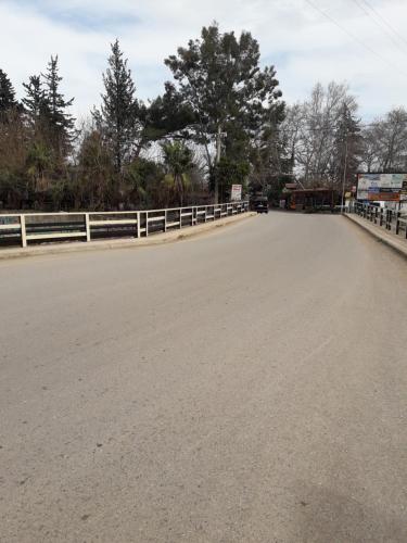 an empty road with a fence on the side at KARAVAN in Kemer