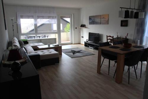 a living room with a couch and a table at Gästewohnung Pakulies in Weinheim