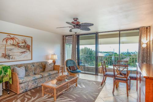 a living room with a couch and a table at Kalanikai 321 in Kailua-Kona
