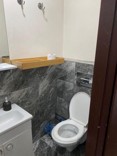 a bathroom with a white toilet and a sink at ortaköy ev daire in Istanbul