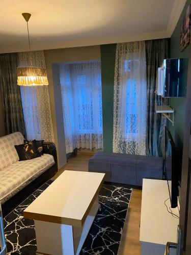 a living room with a couch and a tv at ortaköy ev daire in Istanbul