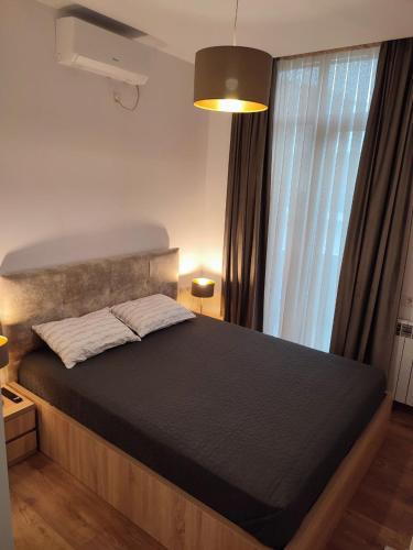 a large bed in a room with a window at European Village Old Villa 6 in Gonio