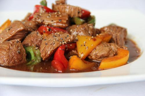 a plate of food with meat and vegetables at Hôtel Huatian Chinagora in Alfortville