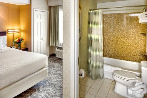 a hotel room with a bed and a bathroom at SpringHill Suites by Marriott Salt Lake City Downtown in Salt Lake City