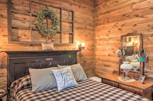 a bedroom with a bed in a log cabin at Missouri Vacation Rental with Fire Pit Access 