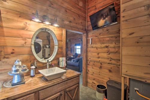a bathroom with a sink and a mirror at Missouri Vacation Rental with Fire Pit Access 