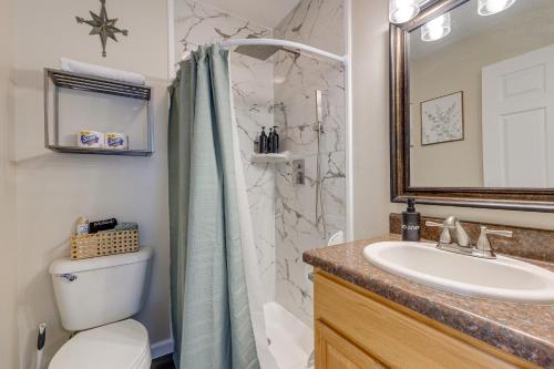 a bathroom with a shower and a toilet and a sink at Charming Biloxi Vacation Rental Near Beach! in Biloxi