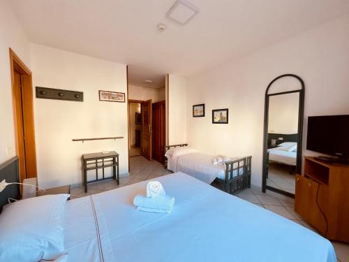 a bedroom with a large bed and a mirror at Baia di Talamone in Talamone