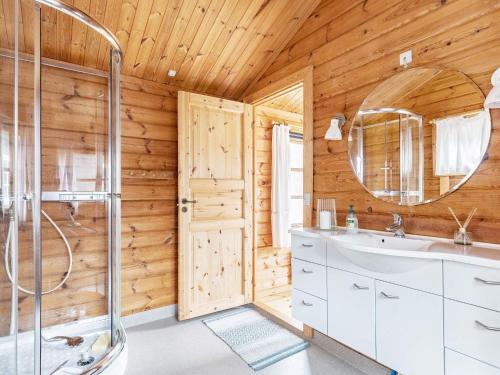 a bathroom with a shower and a sink and a mirror at Holiday home Græsted XXVII in Græsted