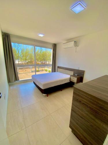 מיטה או מיטות בחדר ב-Residencial Provincia Di Trento Beira Mar