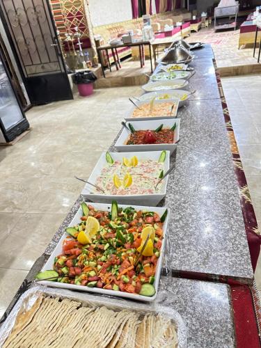 a row of trays of food on a table at Panorama camp jeep trips in Wadi Rum