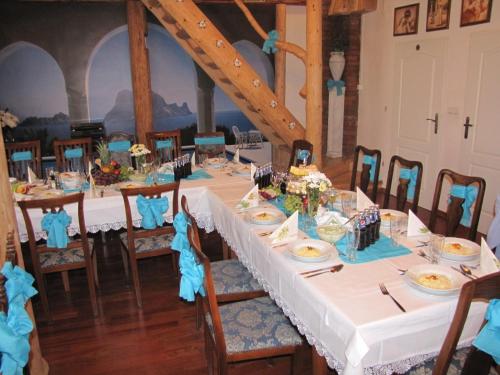 a table set up for a wedding with blue napkins at Gościniec Grek Zorba - pokoje i domki 4 osobowe - 16km od Zator Energylandia in Inwałd