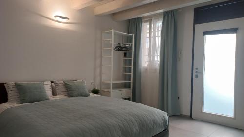 a white bedroom with a bed and a window at Room 28 in Ferrara