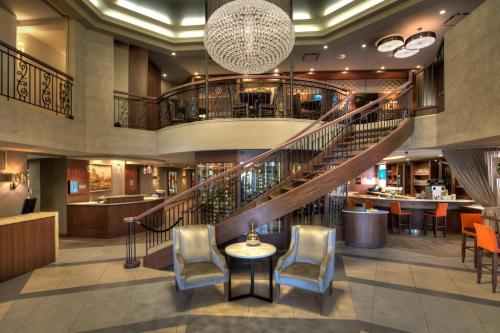 a lobby with a staircase and a bar at Marriott Quebec City Downtown in Quebec City
