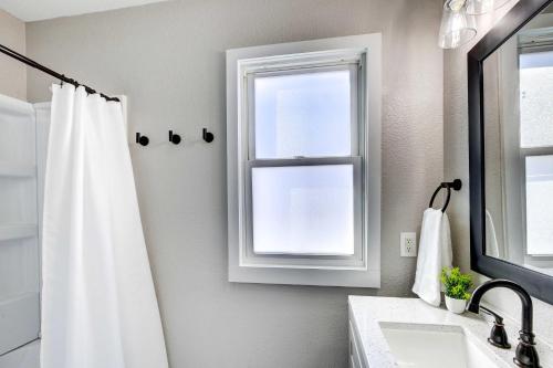 a bathroom with a shower curtain and a window at Rochester Vacation Rental about 1 Mi to Downtown in Rochester