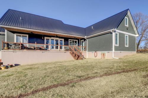 a house with a metal roof on a yard at Spacious Farmhouse Near Hikes and Waterfalls in Harrison