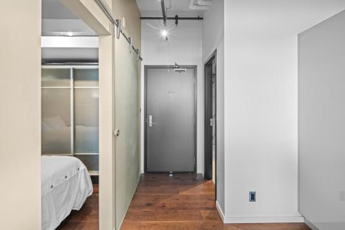 a hallway with a door leading to a bedroom at Jukebox Olympic View by Iris Properties in Victoria