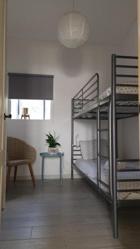 a room with two bunk beds and a table at Monte da ti Luzia in Faro