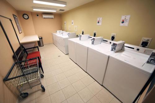 uma lavandaria com uma fila de máquinas de lavar e secar roupa em Residence Inn by Marriott Toronto Vaughan em Vaughan