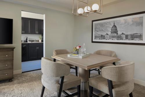 a kitchen and dining room with a table and chairs at Capitol Hill Hotel in Washington