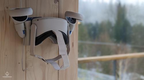 a security camera hanging on a wall with a window at Widokownia Brenna in Brenna