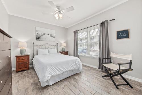a bedroom with a bed and a chair and a window at GulfShores BeachCondo - Pool - FreeParking - SummerTime! - Little Lagoon in Gulf Shores