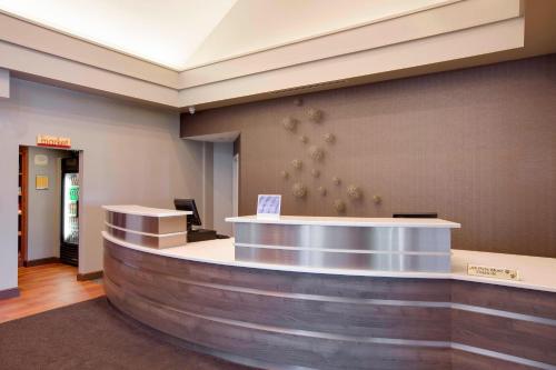 a lobby with a reception counter in a building at Residence Inn Chicago Midway Airport in Bedford Park