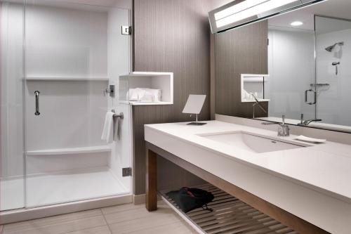 a bathroom with a sink and a shower at Courtyard by Marriott Lehi at Thanksgiving Point in Lehi