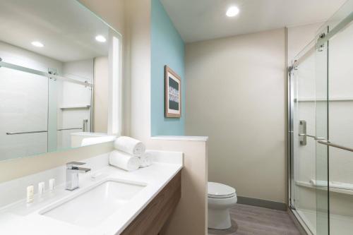 a bathroom with a sink and a glass shower at Fairfield by Marriott Inn & Suites Marathon Florida Keys in Marathon