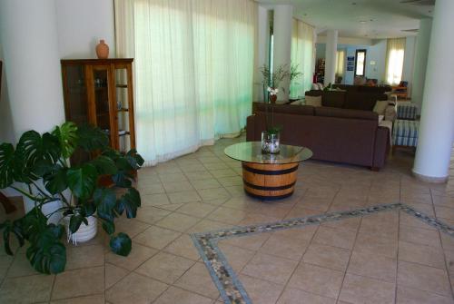 a living room with a couch and a table at Hylatio Tourist Village in Pissouri
