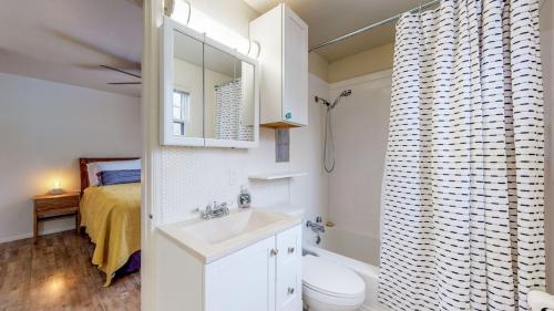 a bathroom with a sink and a toilet and a bed at Book Today! 2 BDR, Pet Friendly, A/C, W/D, Garage in Twin Falls