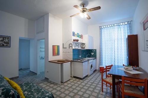 a kitchen and living room with a table and a dining room at Eirene 2 in Tropea