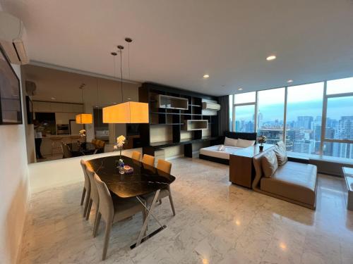 a living room with a dining table and a couch at Pool View Platinum KLCC in Kuala Lumpur