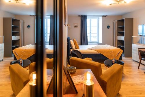 een kamer met twee bedden en een tafel en stoelen bij Escapade Place 11 N3- Studio Dinan centre in Dinan